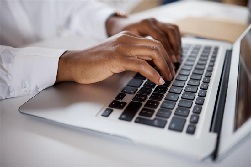 hands typing on a keyboard